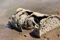 A drop in the water level of a lake reveals remains of human bodies