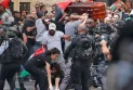 Occupation police beat mourners and drop the journalist's coffin in the midst of chaos