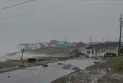 A search is underway for a woman after the sea swept through her house following Hurricane Fiona.