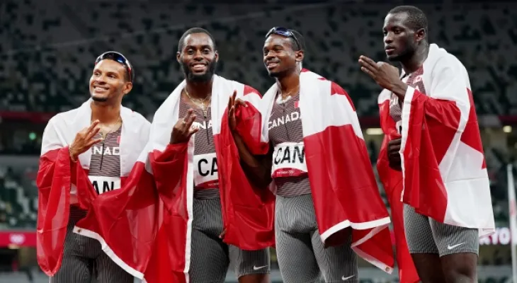 The Canadian men's relay team wins silver medals at the reallocation ceremony.