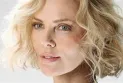 Charlize Theron denies undergoing a failed cosmetic procedure and says, "I’m just getting older."