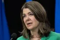 Alberta's Premier orders a review of shared kitchens in Calgary where hundreds of children were infected with E. coli.