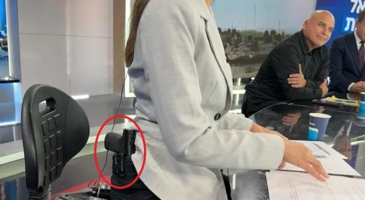 War television…. Israeli anchor appears with a pistol inside the studio