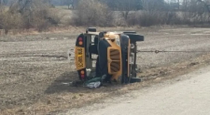 Injury of several children and a driver in a school bus overturn near Woodstock, Ontario