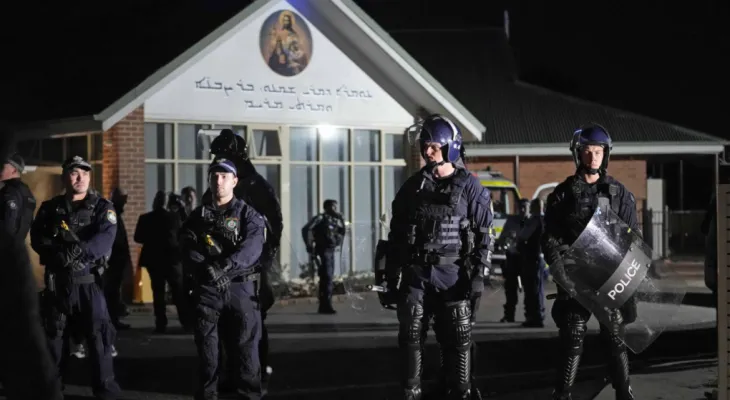 Worshippers in shock watch a bishop being stabbed in a church in Australia.