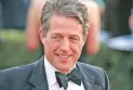 Hugh Grant receives a "huge amount" in settlement of a lawsuit against The Sun newspaper