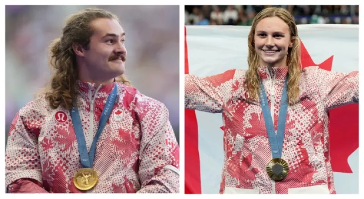 Samar Makntosh and Ethan Katzberg carry the Canadian flag during the Olympic Games closing ceremony.