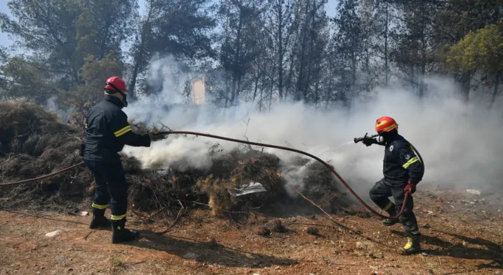 Hundreds of firefighters are battling a massive out-of-control forest fire on the outskirts of the Greek capital.